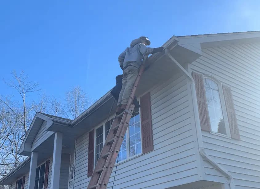 Gutter cleaning and maintenance being performed by Bay Village Power Washing in Bay Village